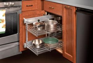 Pull-out storage solution designed and installed by Kitchen Saver in a kitchen with wooden cabinetry