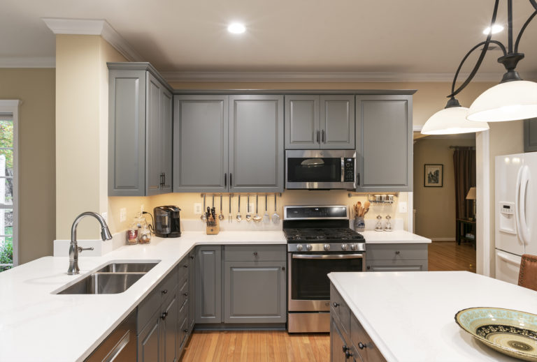 Undercabinet lights highlighting the solid white quartz countertops. 