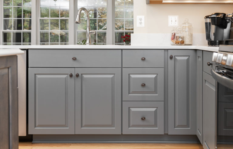 A closer look at the lower cabinets with warm gray tones and oil rubbed bronze hardware. 