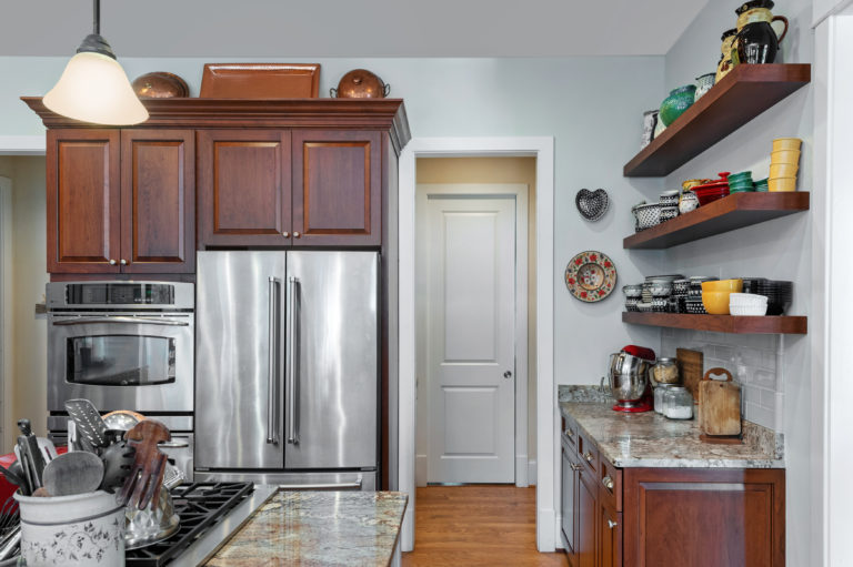 Center raised-panel cabinet doors match the entry doors throughout the home. 