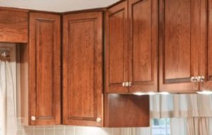 A set of brown hardwood cabinet doors on a kitchen wall