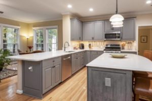 Modern kitchen with gray laminate cabinets and elegant white countertops