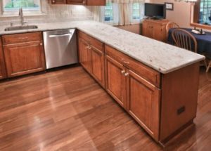 Hardwood cabinets with granite countertops complementing a hardwood floor