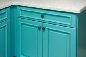 Close-up of stunning blue-green cabinets with a top drawer