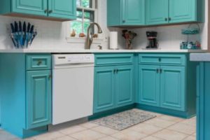 A set of custom, aqua-colored kitchen cabinets 