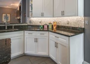 White cabinet doors complementing a dark-colored marble countertop