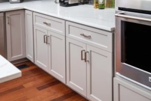 White cabinet doors beautifully complementing dark hardwood floors 