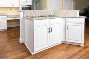 Stunning white cabinets complementing a light-colored countertop on a kitchen island