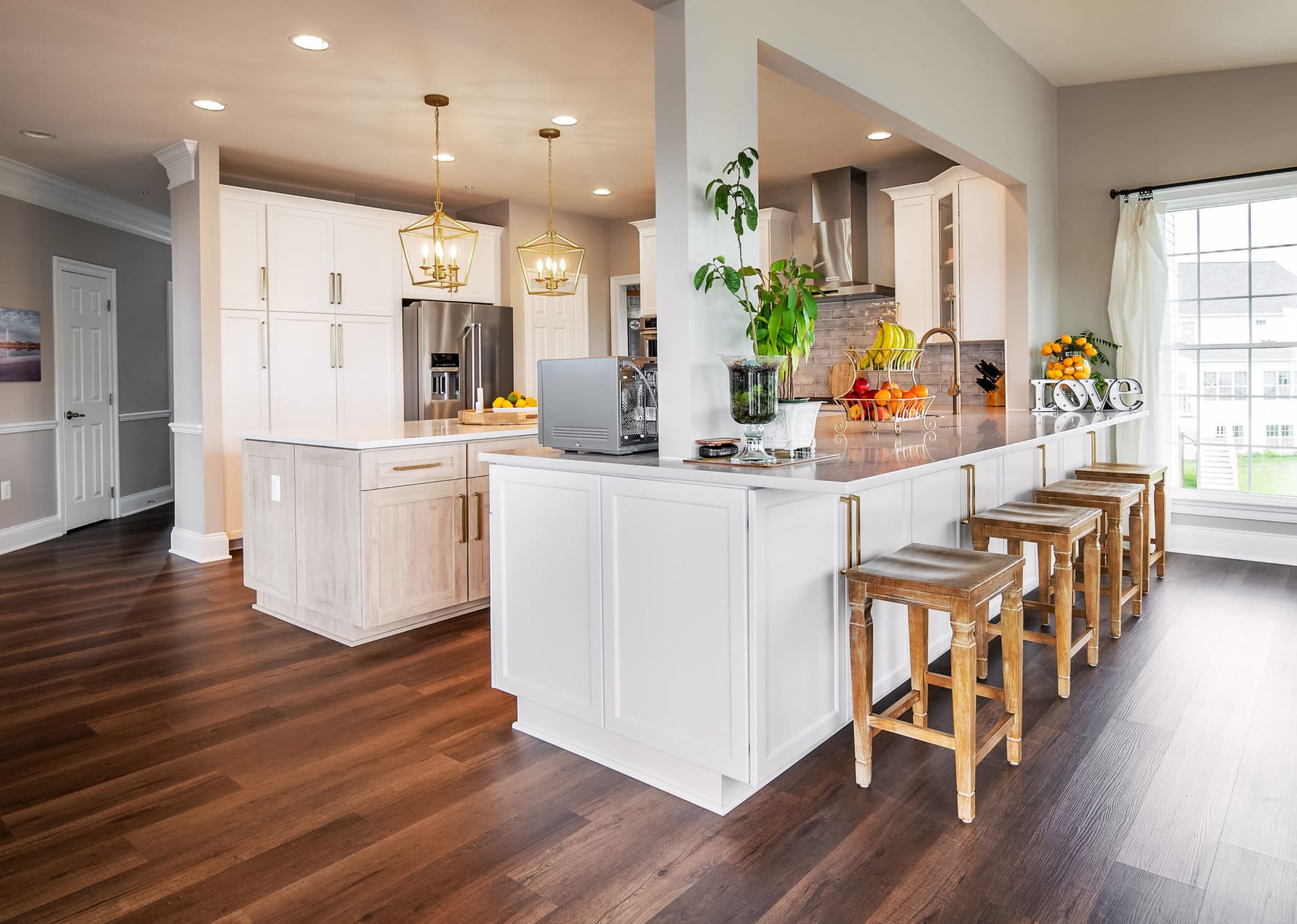 A freshly upgraded kitchen with updated countertops, refaced cabinets, new fixtures, lighting, and more, all by Kitchen Saver