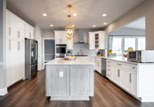 Modern brushed gold finishes on cool white and gray cabinets.