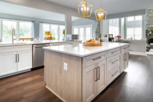 A kitchen with wooden flooring and cabinet installed 