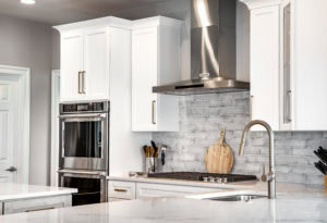 A modern gray subway tile backsplash pulls all the kitchen elements together.