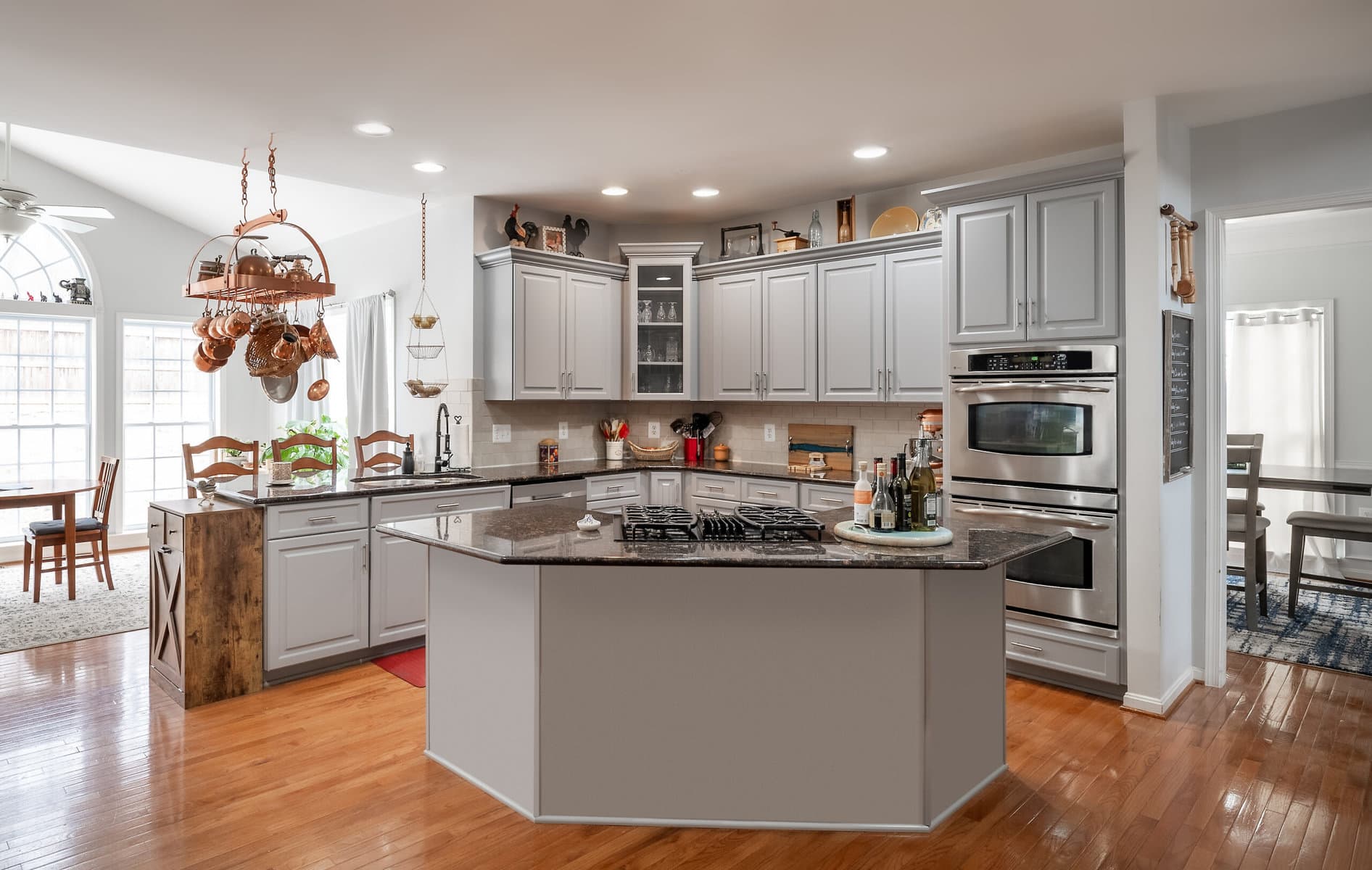 Gray Raised Panel Kitchen with Black Granite Countertops in