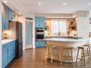 Winter sky blue cabinets and natural maple island white quartz countertop in Severna Park, MD