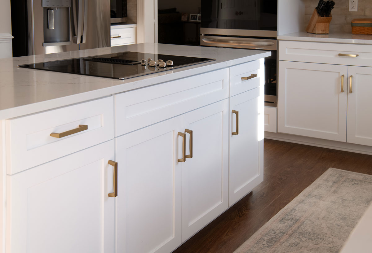 A home kitchen with white refaced kitchen cabinets and gold handles near Owings Mills, MD 