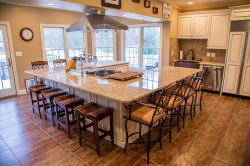 This remarkable kitchen has maple cabinets with presidential doors. A wall was removed to make way for the large island. The island seats 12 or more and features a hibachi cooktop and range hood.
