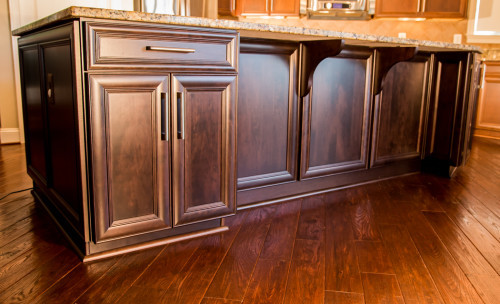 This kitchen was refaced in cherry with Presidential doors. A trash/recycling two-bin pullout was added, along with a knife block and cutlery divider. Structural repairs were done on the cabinet boxes and new glass doors replaced the old ones.