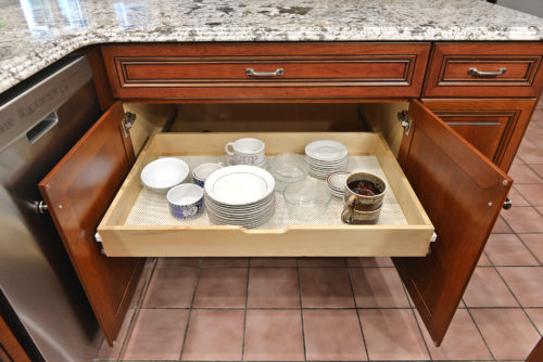 This Manassas, Virginia kitchen was refaced in cherry wood. The raised center panel doors are edged with mitered details that are highlighted with a sable. New Cabinets were added and their contents upgraded with full extension rollouts, a tip out tray, trash can pullout, and a lazy susan.